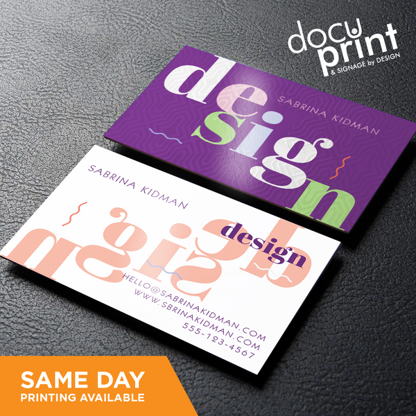 Two business cards with a geometric pattern design, one purple and one white, with the text 'design' and a name. The card on the purple side has the additional text 'inspiration' and a contact number, custom designed and printed by Docuprint in Fremantle, Perth, Australia